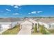 Aerial view of house exterior, showcasing landscaping and driveway at 7836 June Ln, Wildwood, FL 34785