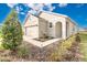 House exterior with two-car garage and well-maintained landscaping at 7836 June Ln, Wildwood, FL 34785