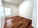 Well-lit bedroom with wood-look floors and a large window at 846 Andalusia Loop, Davenport, FL 33837