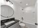 Modern bathroom with a white tiled shower and oval mirror at 1041 Ne 130Th Ter, Silver Springs, FL 34488
