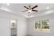 Bright bedroom with ceiling fan and ensuite bathroom at 1041 Ne 130Th Ter, Silver Springs, FL 34488