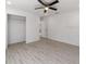 Light bedroom featuring ceiling fan and wood-look floors at 1041 Ne 130Th Ter, Silver Springs, FL 34488