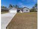 New gray house with a two-car garage and a large yard at 1041 Ne 130Th Ter, Silver Springs, FL 34488
