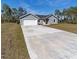 New home exterior with driveway and landscaping at 1041 Ne 130Th Ter, Silver Springs, FL 34488