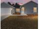 Gray house with a two-car garage and a well-manicured lawn at 1041 Ne 130Th Ter, Silver Springs, FL 34488