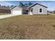 Newly built house with a driveway and small front yard at 1041 Ne 130Th Ter, Silver Springs, FL 34488