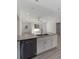 Modern kitchen island with granite countertops and stainless steel dishwasher at 1041 Ne 130Th Ter, Silver Springs, FL 34488