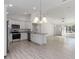 Kitchen with island, stainless steel appliances, and white cabinets at 1041 Ne 130Th Ter, Silver Springs, FL 34488