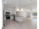 Open kitchen with island and stainless steel appliances at 1041 Ne 130Th Ter, Silver Springs, FL 34488