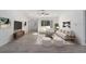Living room features light walls, wood-look floors, and large windows at 1041 Ne 130Th Ter, Silver Springs, FL 34488