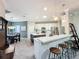 Elegant kitchen boasting white cabinetry, a sizable island, and breakfast bar at 14377 Black Quill Dr, Winter Garden, FL 34787