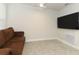 Relaxing media room with a brown couch and mounted TV at 1949 Victoria St, Davenport, FL 33837