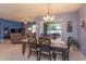 Bright dining room featuring a table with six chairs, and view to backyard at 217 Wood Hollow Rd, Deland, FL 32724