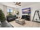 Living room with fireplace, large TV, and a view into the dining area at 2469 Seven Oaks Dr, Saint Cloud, FL 34772