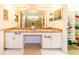 Double vanity bathroom with granite countertops and large mirror at 4027 Oakrise Loop, Davenport, FL 33837