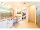 Modern bathroom boasts double vanity, granite countertops, and large shower at 4027 Oakrise Loop, Davenport, FL 33837