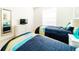 Bedroom with twin beds, dresser, TV, and a full-length mirror at 4027 Oakrise Loop, Davenport, FL 33837