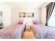 Well-lit bedroom featuring two twin beds, neutral decor, and ample natural light at 4027 Oakrise Loop, Davenport, FL 33837