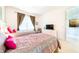 Spacious bedroom with twin beds, TV, and access to a bathroom at 4027 Oakrise Loop, Davenport, FL 33837