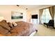 Primary bedroom features large TV and comfortable seating at 4027 Oakrise Loop, Davenport, FL 33837
