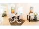 Modern dining area with white table and four uniquely designed chairs at 4027 Oakrise Loop, Davenport, FL 33837