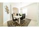 Modern dining room with white table, black chairs and geometric rug at 4027 Oakrise Loop, Davenport, FL 33837