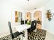 Bright dining room featuring a white table, black chairs, and modern art at 4027 Oakrise Loop, Davenport, FL 33837
