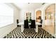 Modern dining room with white table, black chairs and geometric rug at 4027 Oakrise Loop, Davenport, FL 33837