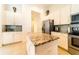 Island kitchen features granite countertops and white cabinets at 4027 Oakrise Loop, Davenport, FL 33837