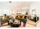 Open concept living room showcasing stylish furniture and views into kitchen and dining areas at 4027 Oakrise Loop, Davenport, FL 33837