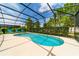 Sparkling pool with screened patio and lounge chairs at 4027 Oakrise Loop, Davenport, FL 33837