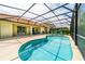Refreshing kidney-shaped pool with screened enclosure at 4027 Oakrise Loop, Davenport, FL 33837