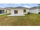 Newly constructed home with a large backyard and a patio at 4404 Desert Rose Ave, Kissimmee, FL 34746