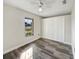 Spacious bedroom with wood-look floors and large closet at 5933 Bible Camp Rd, Groveland, FL 34736