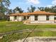 Single-story home with brown roof and well-maintained lawn at 5933 Bible Camp Rd, Groveland, FL 34736