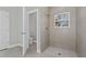 Clean bathroom with walk-in shower, toilet and gray tile at 6215 148Th Southwest, Ocala, FL 34473