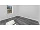 Bright bedroom with wood-look floors and a window at 6215 148Th Southwest, Ocala, FL 34473