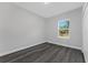 Simple bedroom with gray vinyl flooring and a window offering natural light at 6215 148Th Southwest, Ocala, FL 34473