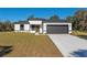 Modern, single-story home with white walls, black trim, and a two-car garage at 6215 148Th Southwest, Ocala, FL 34473