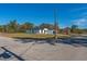 Single-story home with white exterior, black garage door, and a grassy yard at 6215 148Th Southwest, Ocala, FL 34473