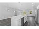 Kitchen island with quartz countertop and pendant lights at 6215 148Th Southwest, Ocala, FL 34473