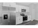 Stainless steel appliances and white cabinets in kitchen at 6215 148Th Southwest, Ocala, FL 34473