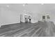 Open living room and kitchen with grey wood-look floors at 6215 148Th Southwest, Ocala, FL 34473
