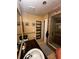 Bathroom with tiled floors, shower, and shelving at 761 Americana Ct, Kissimmee, FL 34758