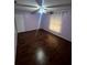 Light and airy bedroom with hardwood floors at 761 Americana Ct, Kissimmee, FL 34758
