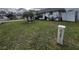 Landscaped front yard with lush grass and a mature palm tree at 761 Americana Ct, Kissimmee, FL 34758