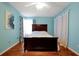 Bright bedroom with wood floors, a double bed, and light blue walls at 9261 Lake Lotta Cir, Gotha, FL 34734