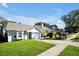 Cute light blue house with a nicely landscaped lawn at 9261 Lake Lotta Cir, Gotha, FL 34734