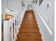 Wooden staircase with white railings leading to the second floor at 9261 Lake Lotta Cir, Gotha, FL 34734