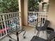 Spacious balcony overlooking parking lot with two chairs and table at 1223 Arbor Lakes Cir, Sanford, FL 32771